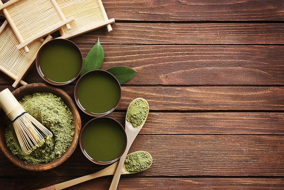 Top view of traditional matcha tea setup with utensils on a wooden table, showcasing a blend of culture and flavor.